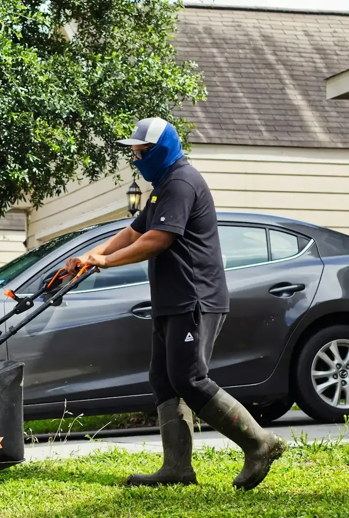 Landscaper mowing a lawn