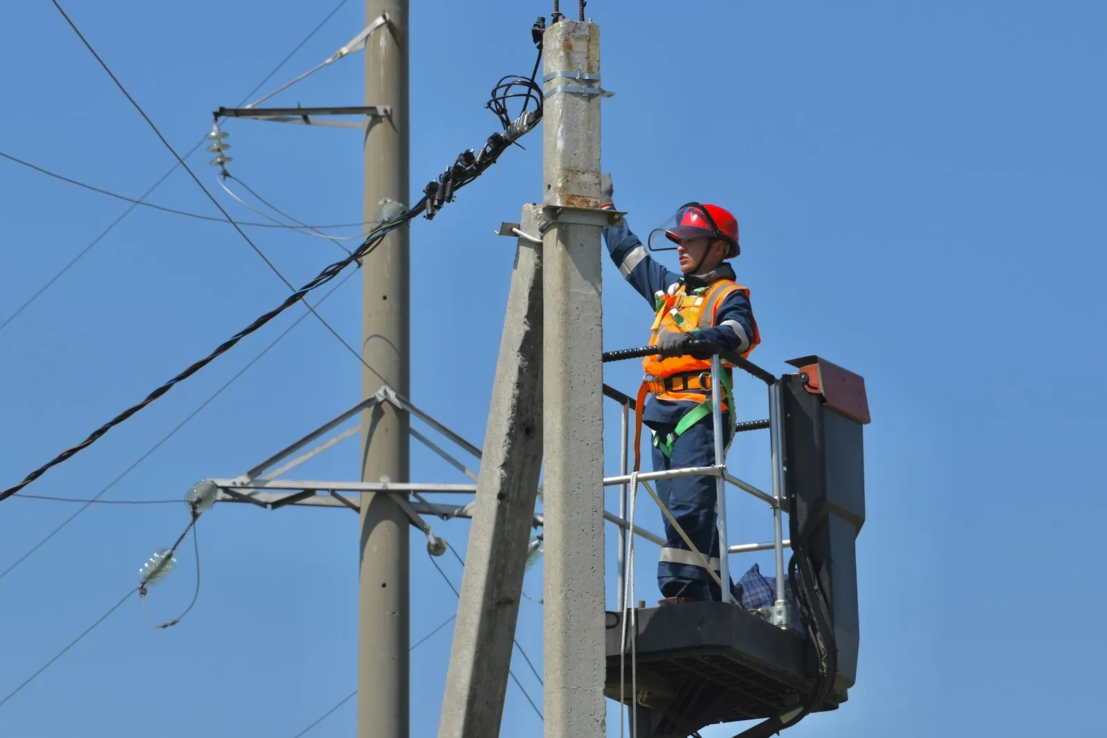 Lineman in a bucket truck working on a utility pole
